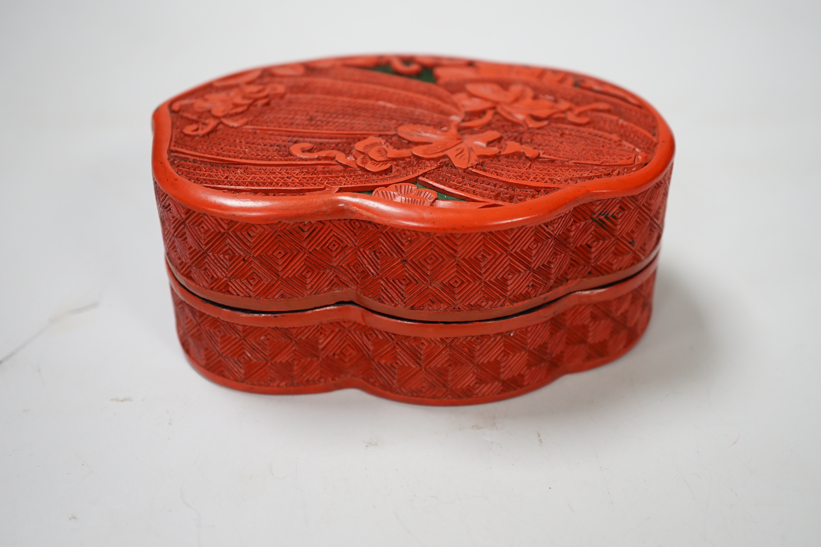 A Chinese cinnabar lacquer box and cover, decorated with bitter melons, 12cm high